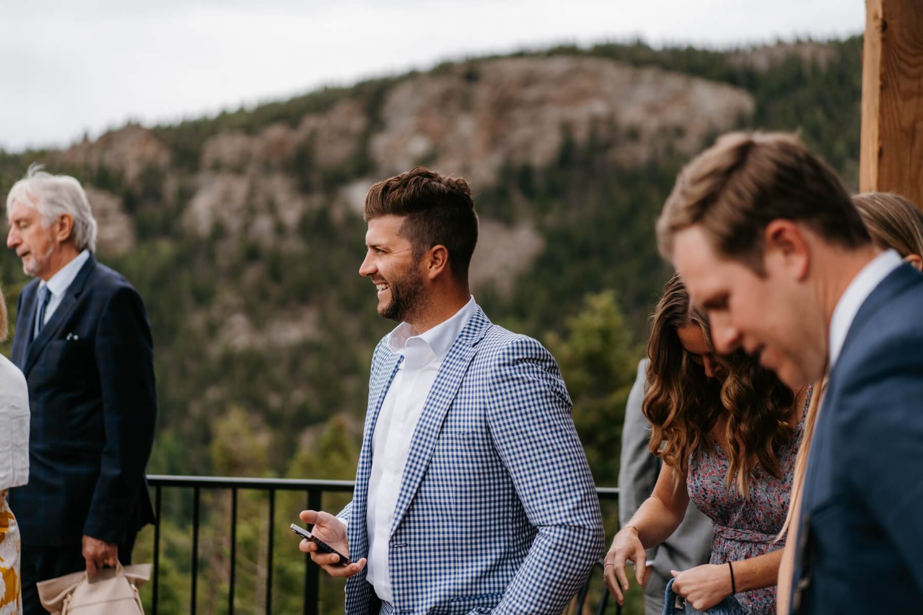 Man standing outside during cocktail hour at wedding | McArthur Weddings and Events