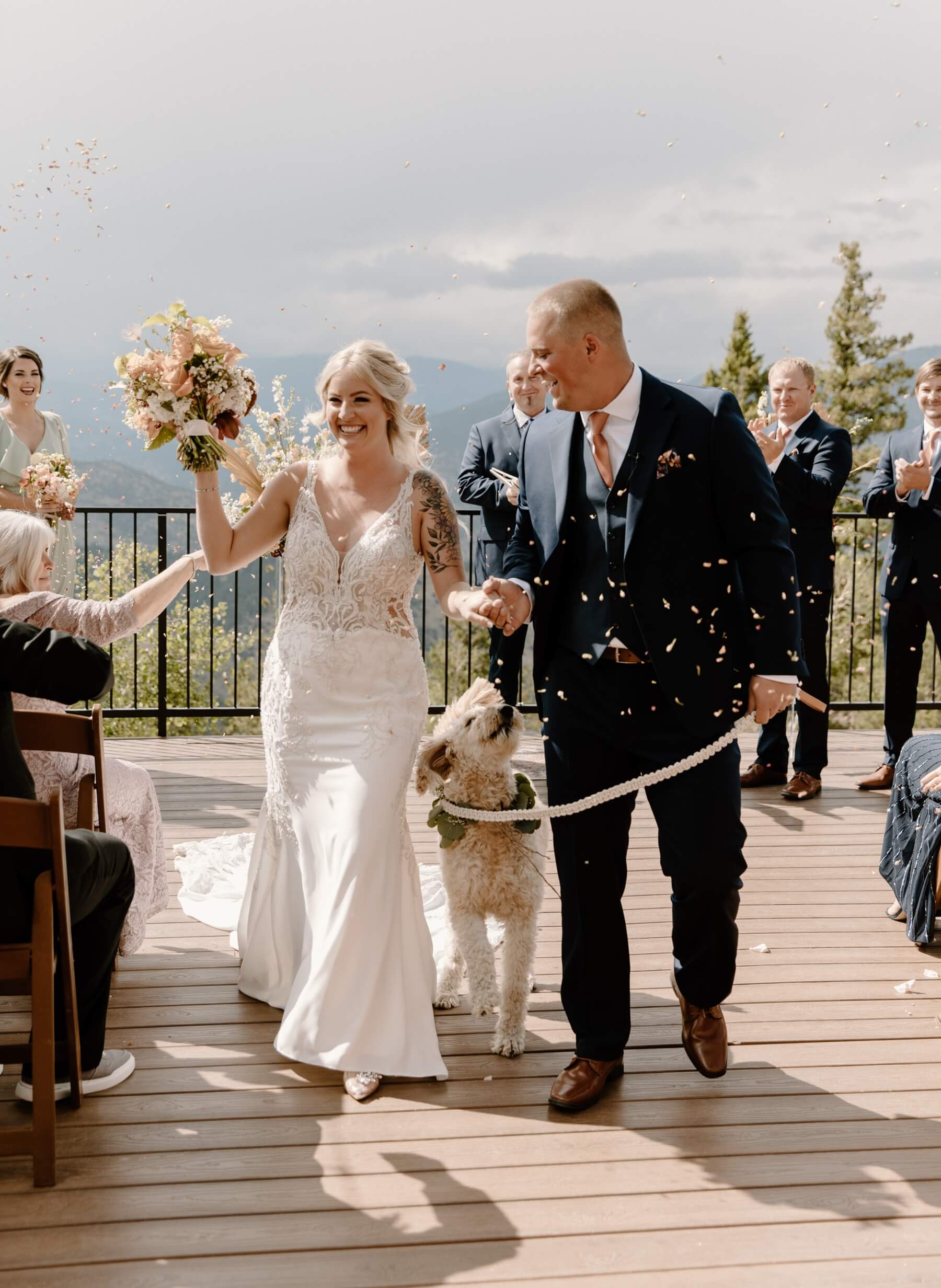 Bride and groom exiting ceremony with dog at Idaho Springs wedding venue | McArthur Weddings and Events