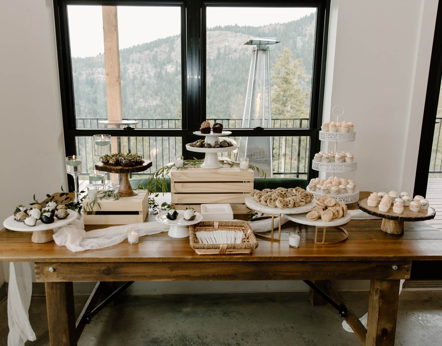 Dessert table with cookies, chocolate covered strawberries, and cupcakes at Idaho Springs Wedding venue | McArthur Weddings and Events