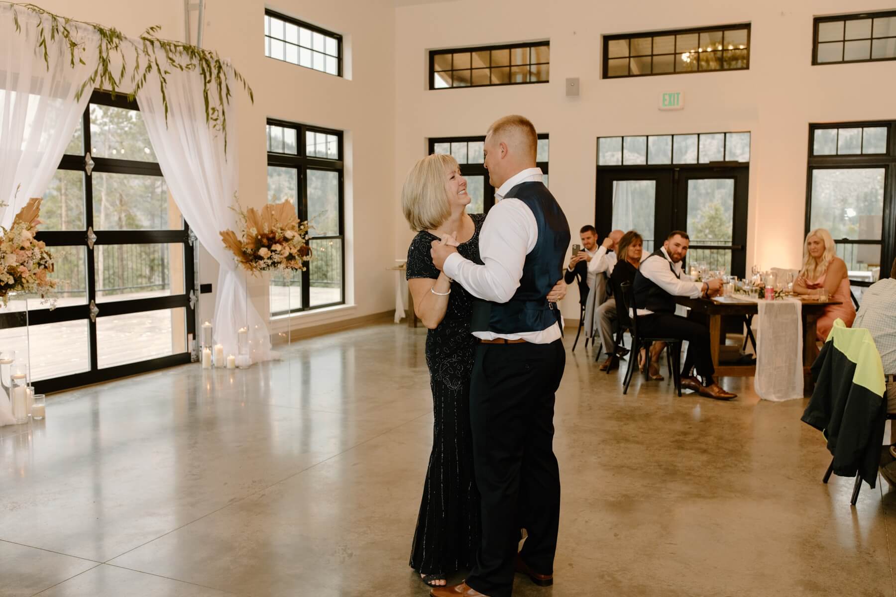 Groom dancing with mom during reception at idaho springs wedding venue | McArthur Weddings and Events