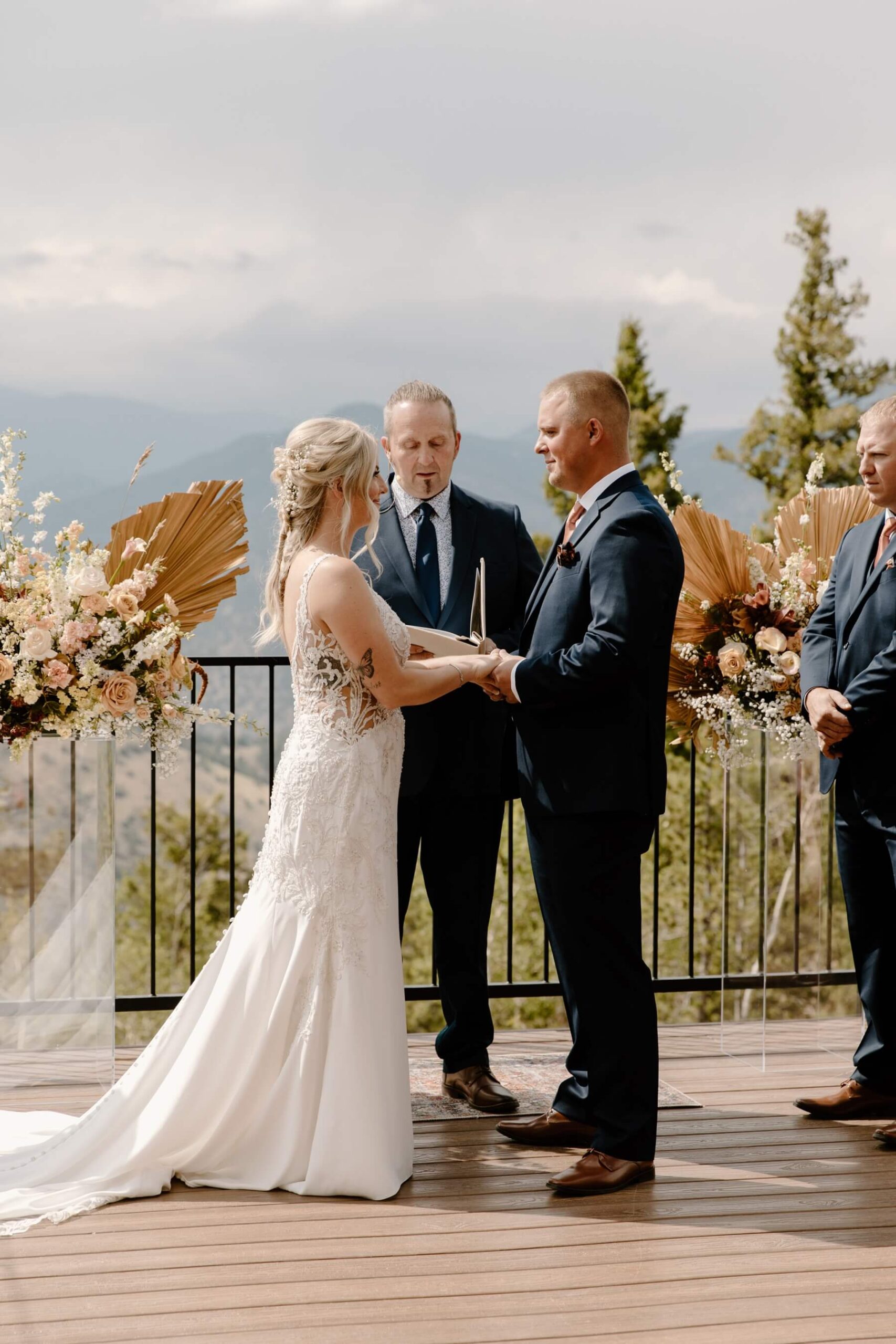 Bride and groom holding hands at altar during ceremony at North Star Gatherings | McArthur Weddings and Events
