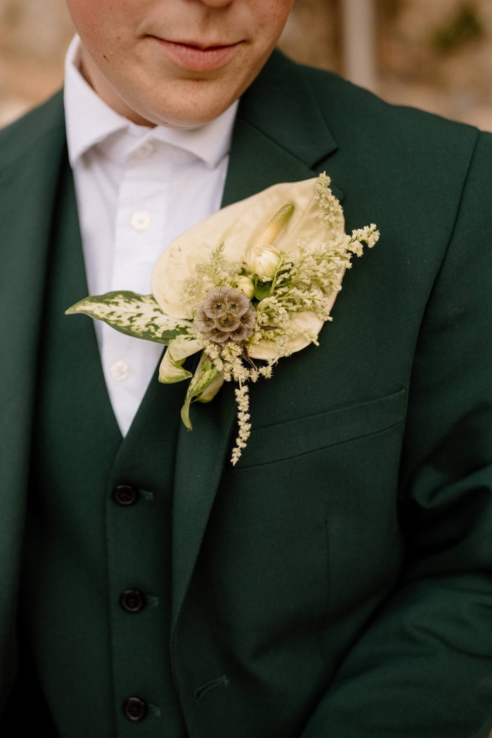 Green and white wedding boutonniere 