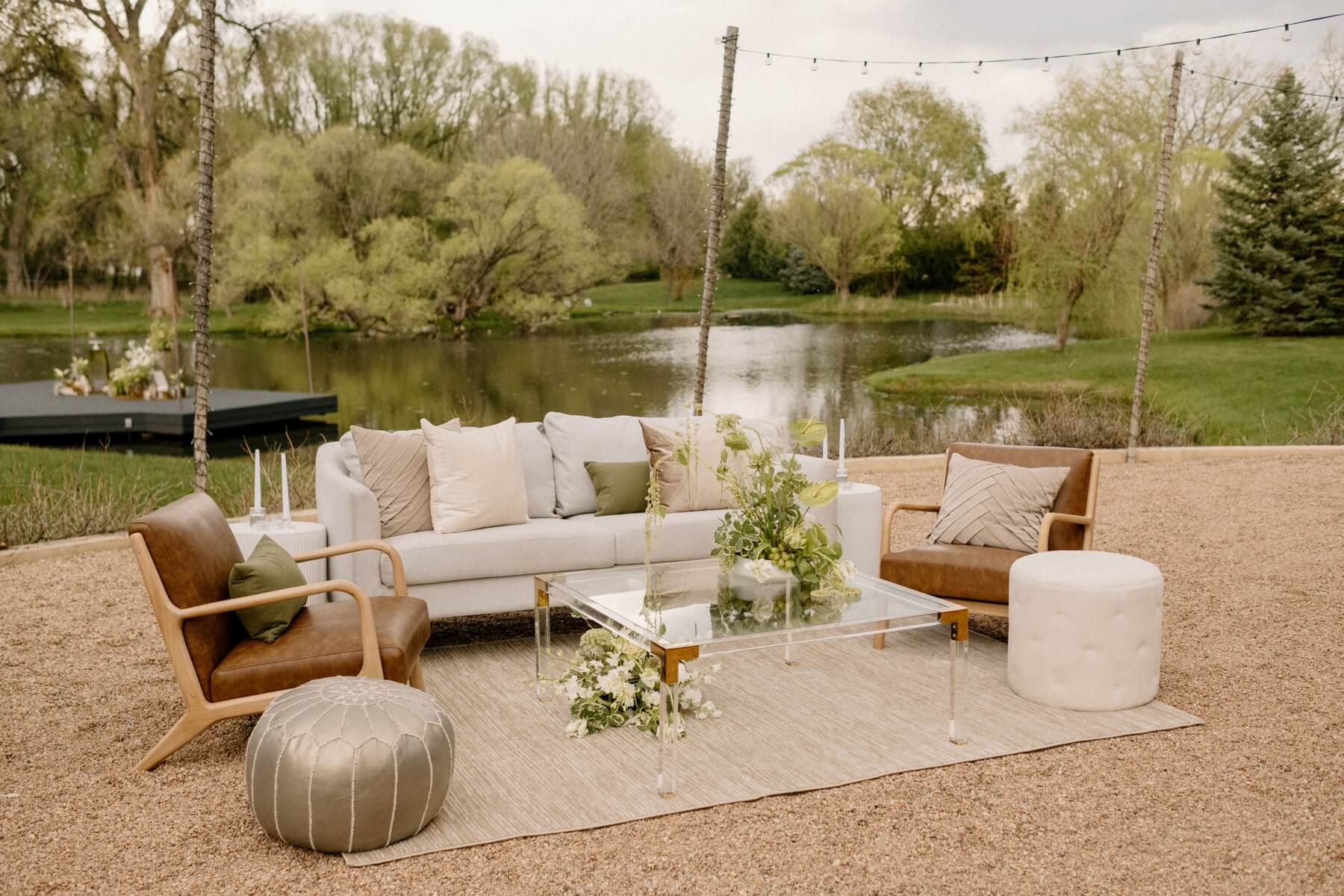Lounge set with cream couch and brown leather chairs at styled shoot