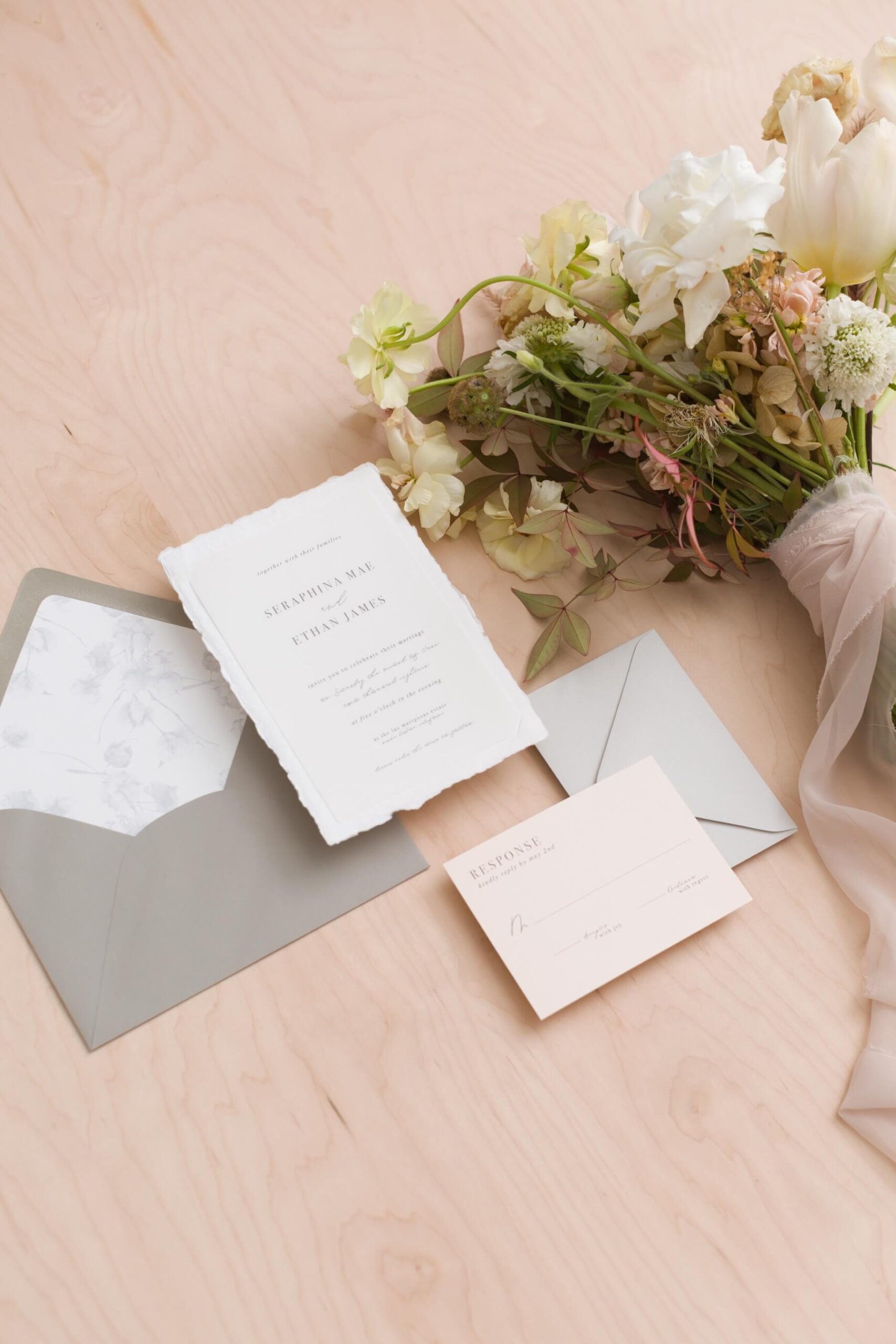 Wedding invitation with RSVP card and a bouquet of flowers