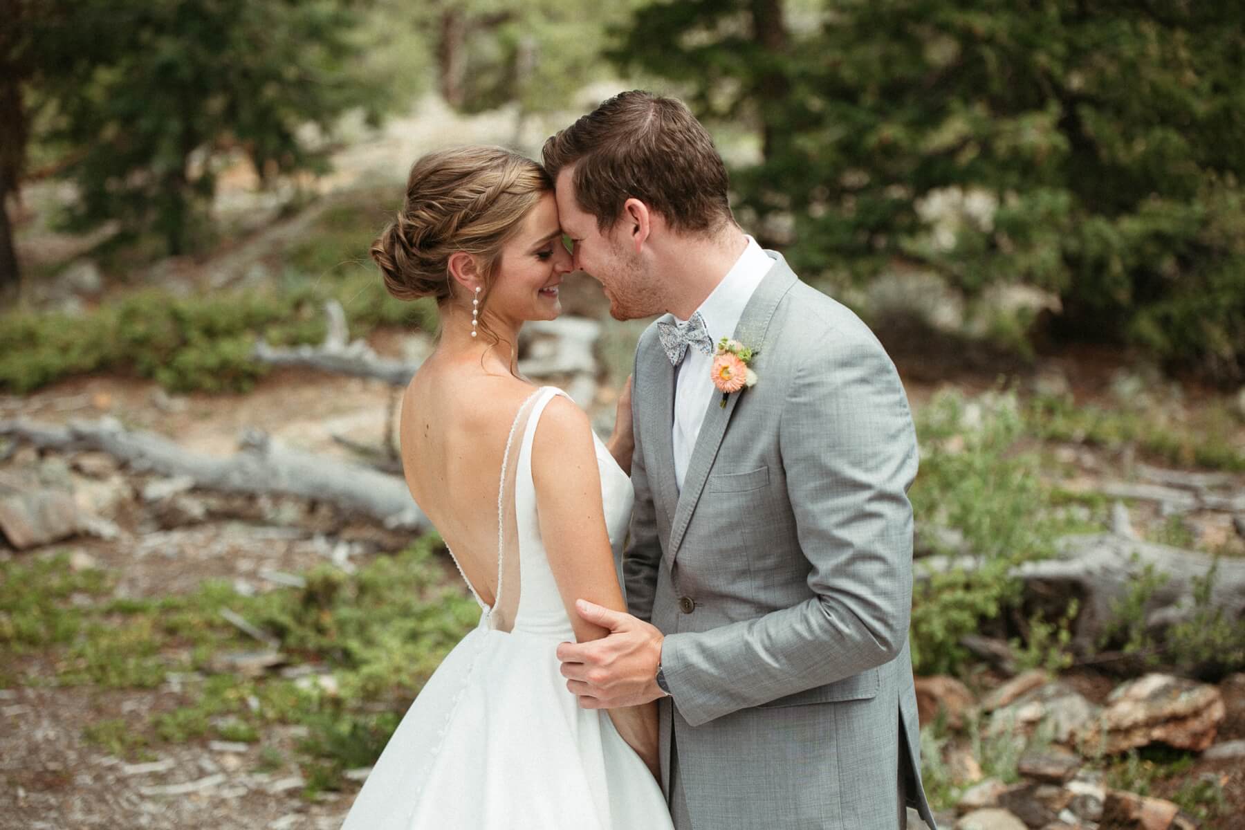 Bride and groom touching foreheads during couple's photos at North Star Gatherings, a Colorado mountain wedding venue