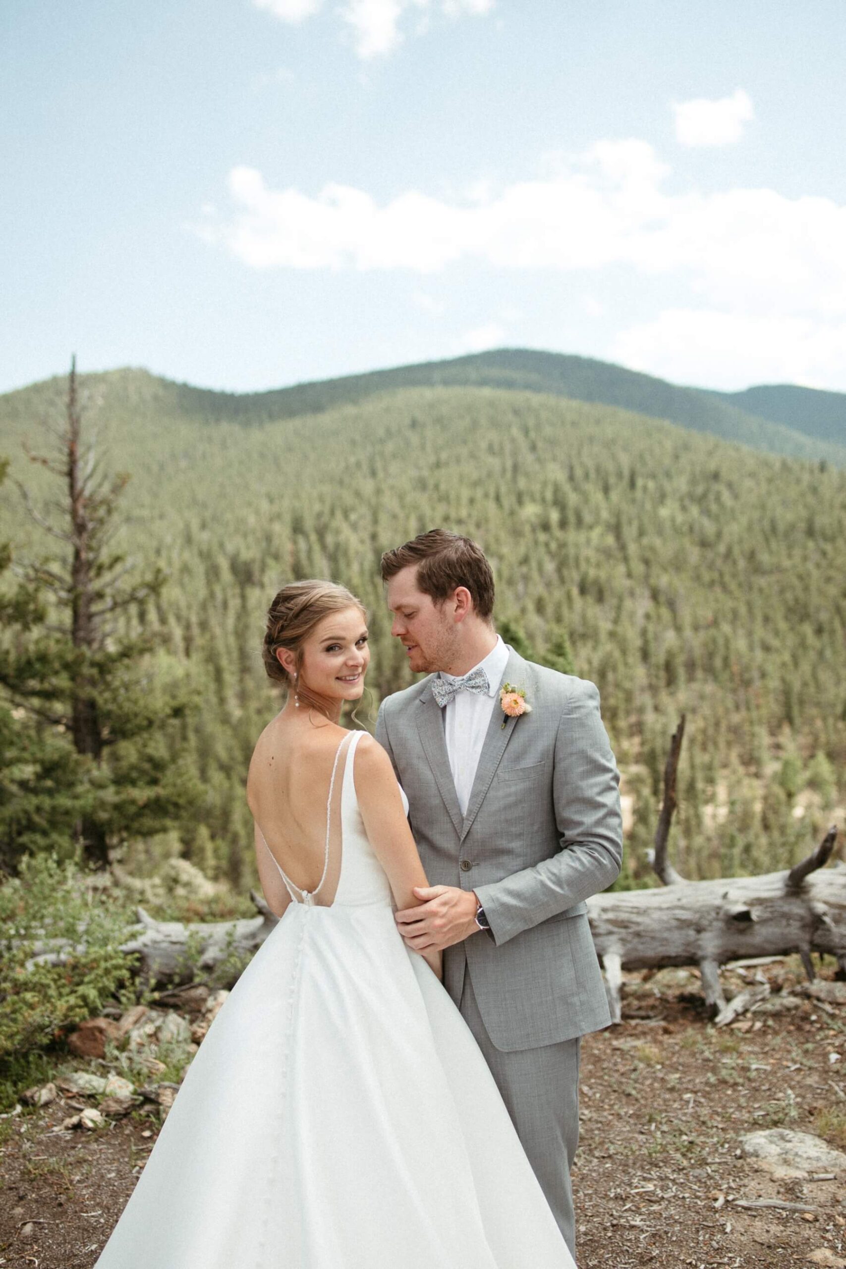Groom looking at bride as she looks at camera at North Star Gatherings, a Colorado mountain wedding venue