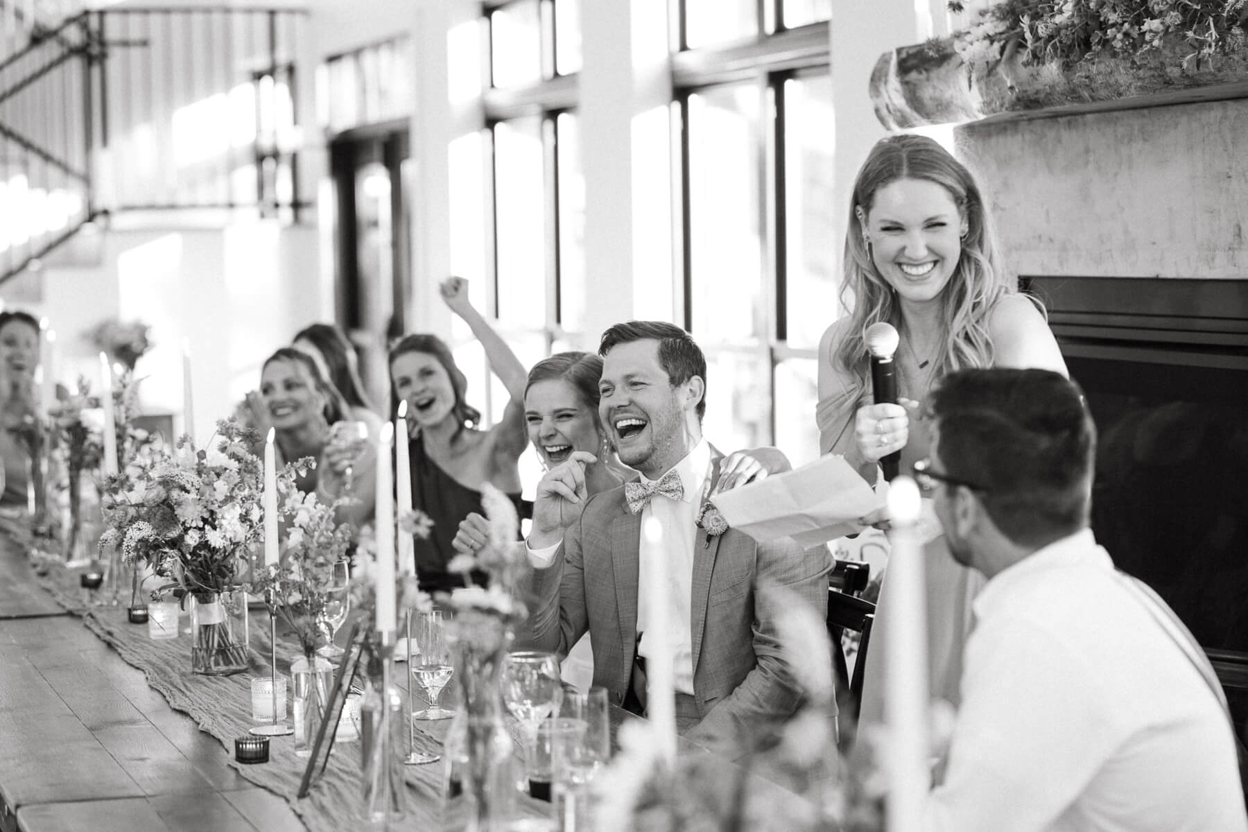 Bride and groom laughing during toast at North Star Gatherings