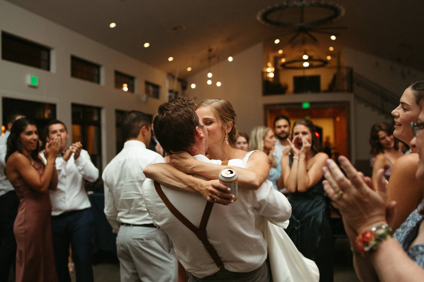 Bride and groom kissing during wedding reception 