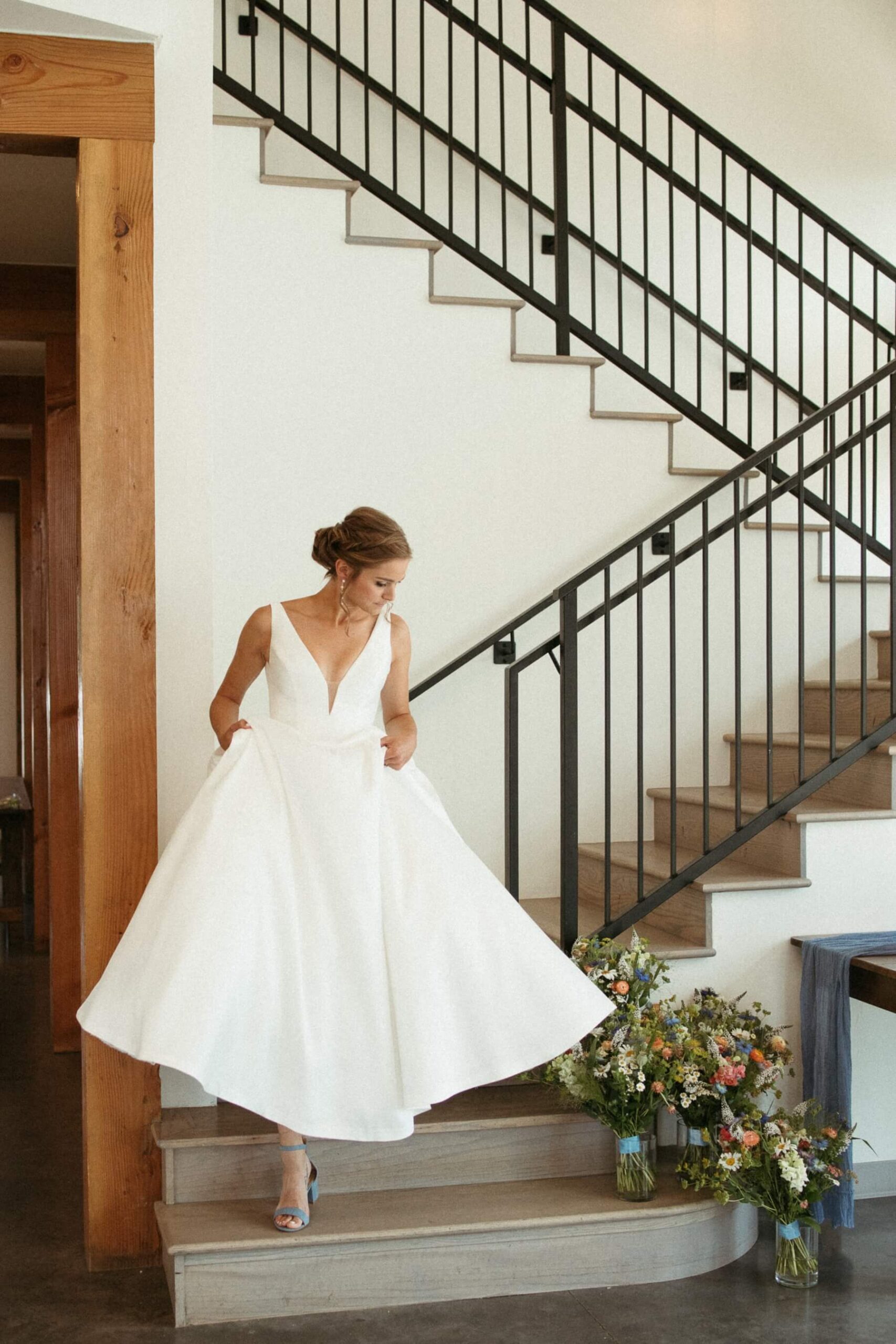 Bride walking down the stairs at North Star Gatherings, a Colorado mountain wedding venue