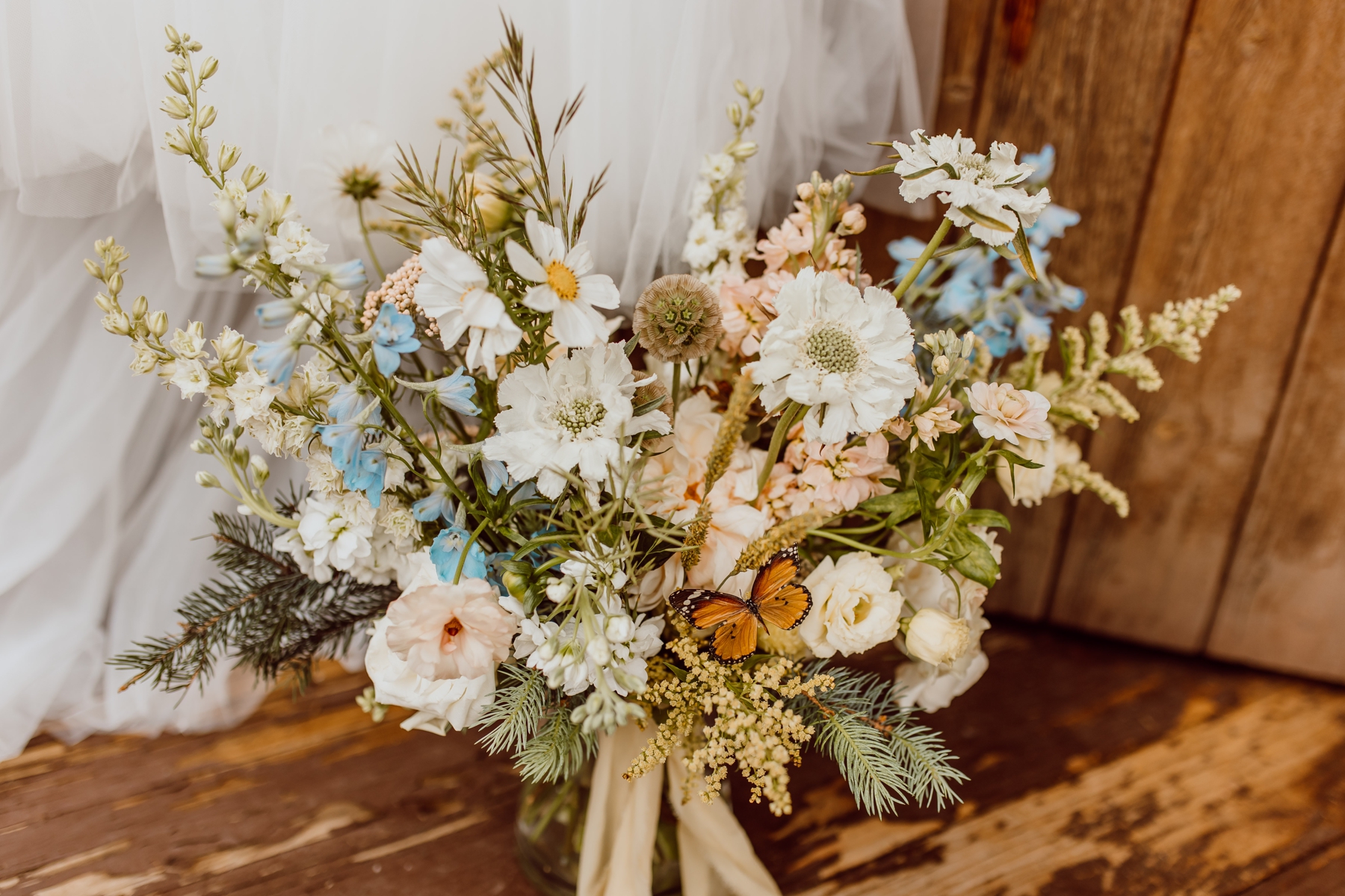 Bridal bouquet full of wildflowers and butterflies 