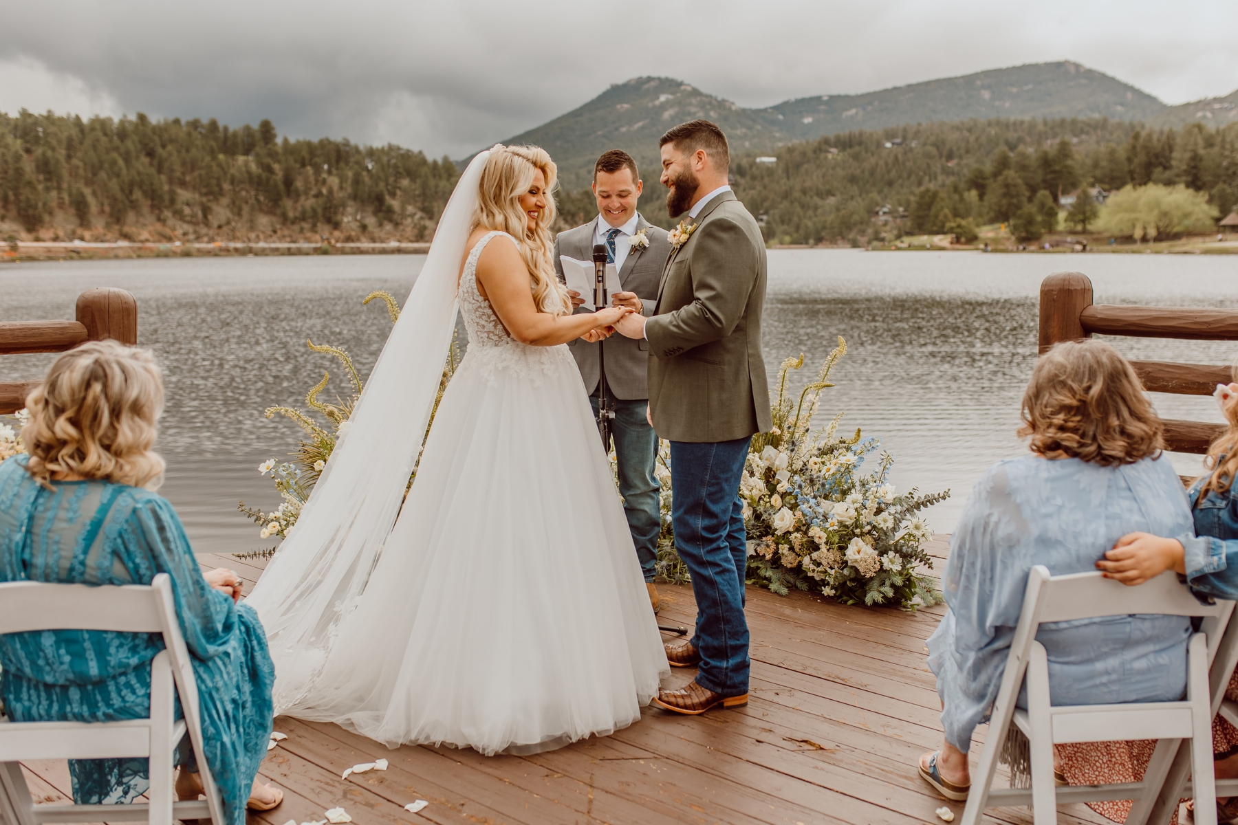 Bride and groom holding hands during ceremony at Evergreen Lake House