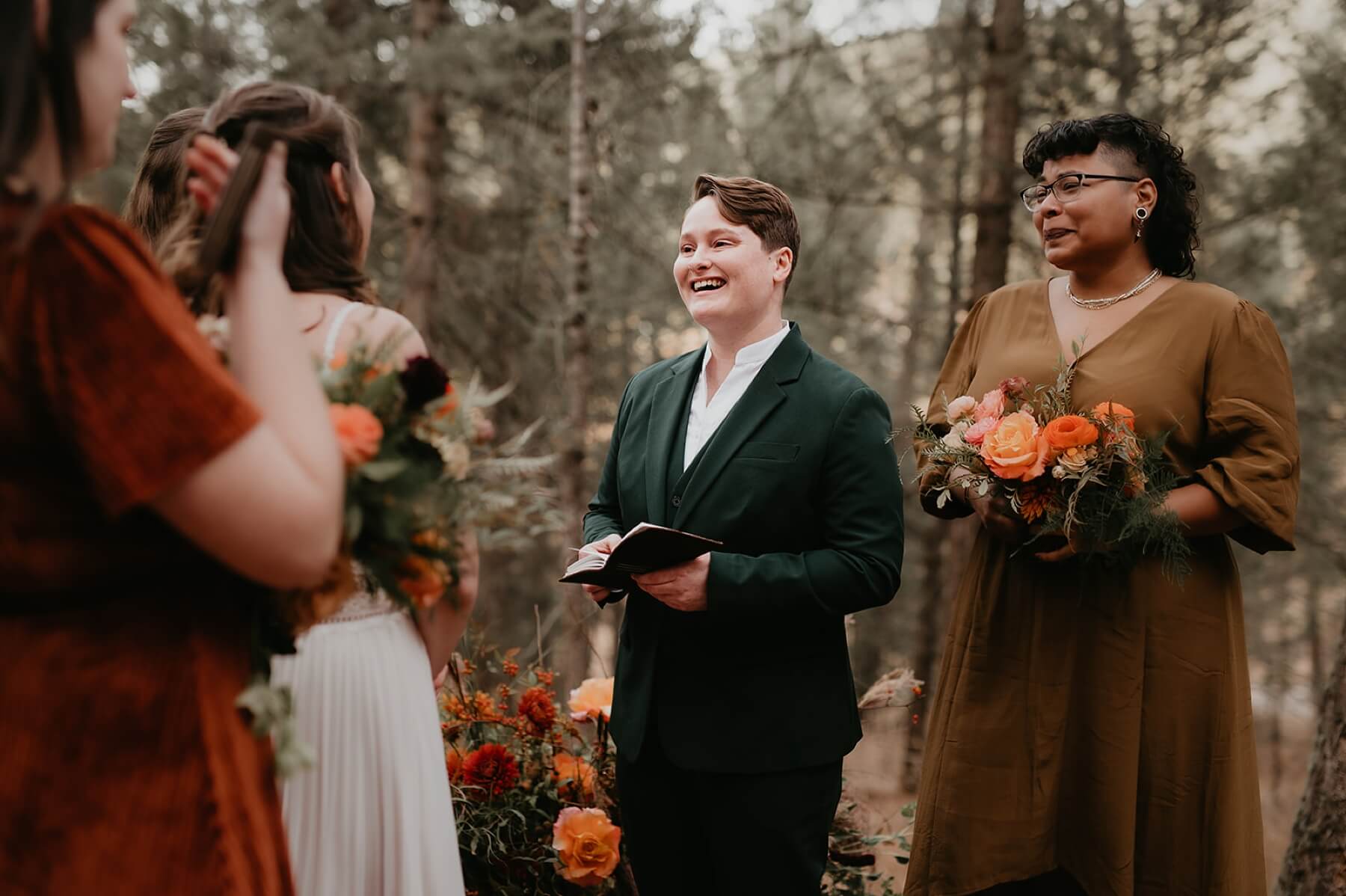 Maid of honor standing next to couple as they exchange vows