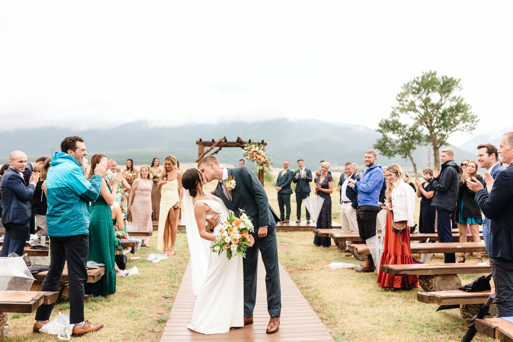 Bride and groom kissing during ceremony exit at The Barn at Sunset Ranch